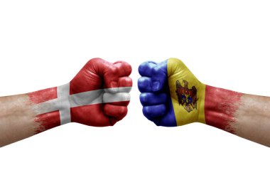 Two hands punch to each others on white background. Country flags painted fists, conflict crisis concept between denmark and moldova