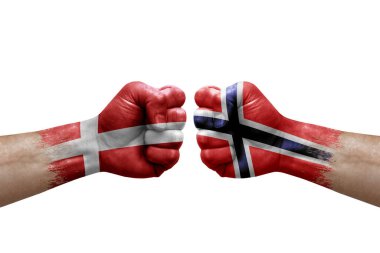 Two hands punch to each others on white background. Country flags painted fists, conflict crisis concept between denmark and norway