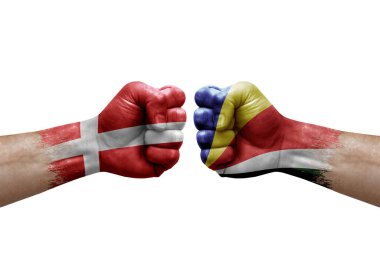 Two hands punch to each others on white background. Country flags painted fists, conflict crisis concept between denmark and seychelles