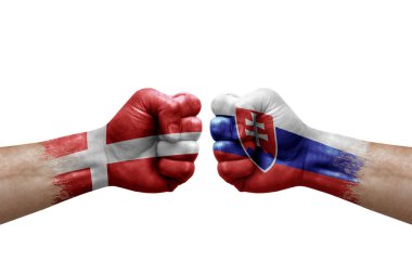 Two hands punch to each others on white background. Country flags painted fists, conflict crisis concept between denmark and slovakia
