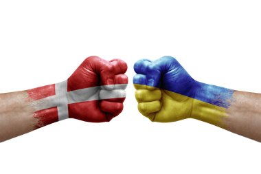 Two hands punch to each others on white background. Country flags painted fists, conflict crisis concept between denmark and ukraine