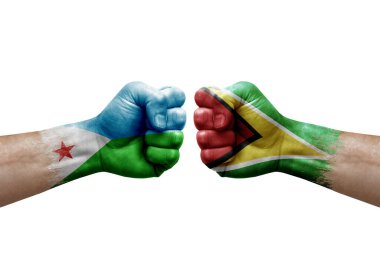Two hands punch to each others on white background. Country flags painted fists, conflict crisis concept between djibouti and guyana