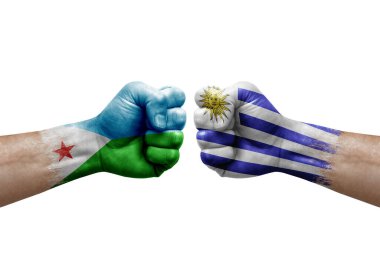 Two hands punch to each others on white background. Country flags painted fists, conflict crisis concept between djibouti and uruguay