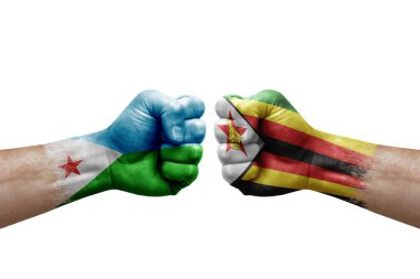 Two hands punch to each others on white background. Country flags painted fists, conflict crisis concept between djibouti and zimbabwe
