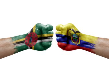 Two hands punch to each others on white background. Country flags painted fists, conflict crisis concept between dominica and ecuador