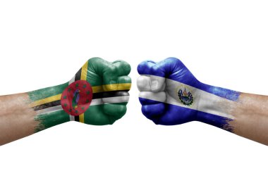 Two hands punch to each others on white background. Country flags painted fists, conflict crisis concept between dominica and el salvador