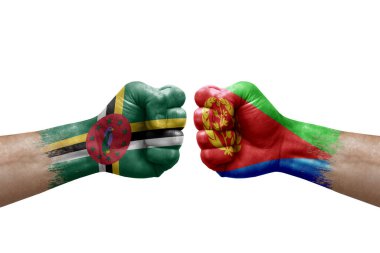 Two hands punch to each others on white background. Country flags painted fists, conflict crisis concept between dominica and eritrea