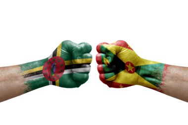 Two hands punch to each others on white background. Country flags painted fists, conflict crisis concept between dominica and grenada