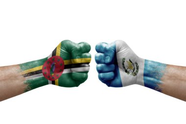 Two hands punch to each others on white background. Country flags painted fists, conflict crisis concept between dominica and guatemala