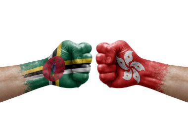 Two hands punch to each others on white background. Country flags painted fists, conflict crisis concept between dominica and hong kong