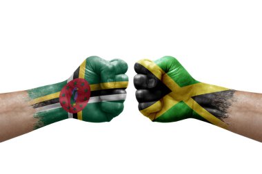 Two hands punch to each others on white background. Country flags painted fists, conflict crisis concept between dominica and jamaica