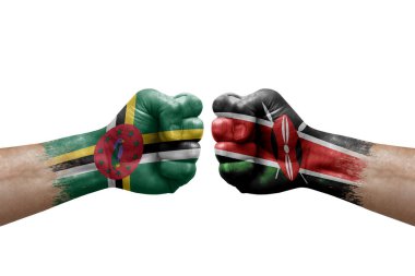 Two hands punch to each others on white background. Country flags painted fists, conflict crisis concept between dominica and kenya