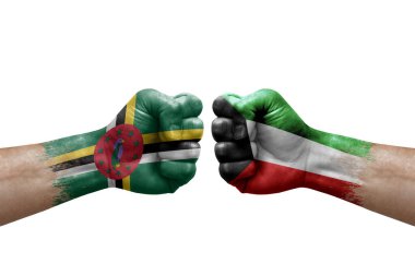 Two hands punch to each others on white background. Country flags painted fists, conflict crisis concept between dominica and kuwait