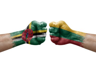Two hands punch to each others on white background. Country flags painted fists, conflict crisis concept between dominica and lithuania