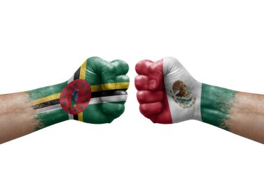 Two hands punch to each others on white background. Country flags painted fists, conflict crisis concept between dominica and mexico