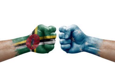 Two hands punch to each others on white background. Country flags painted fists, conflict crisis concept between dominica and micronesia