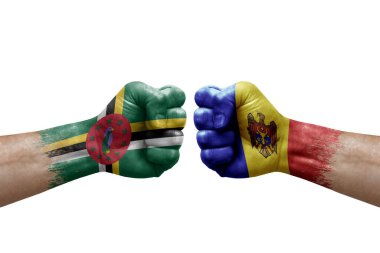 Two hands punch to each others on white background. Country flags painted fists, conflict crisis concept between dominica and moldova