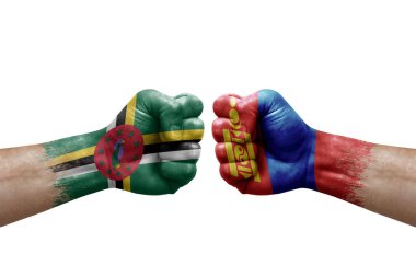 Two hands punch to each others on white background. Country flags painted fists, conflict crisis concept between dominica and mongolia