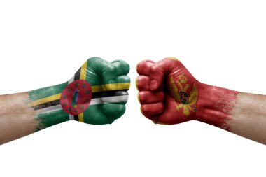 Two hands punch to each others on white background. Country flags painted fists, conflict crisis concept between dominica and montenegro