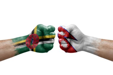 Two hands punch to each others on white background. Country flags painted fists, conflict crisis concept between dominica and nepal