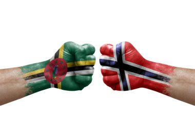 Two hands punch to each others on white background. Country flags painted fists, conflict crisis concept between dominica and norway