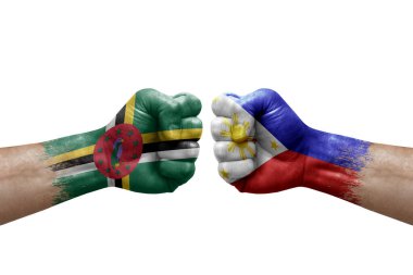 Two hands punch to each others on white background. Country flags painted fists, conflict crisis concept between dominica and philippines