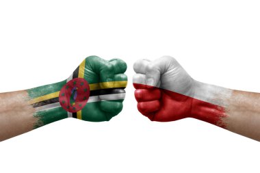Two hands punch to each others on white background. Country flags painted fists, conflict crisis concept between dominica and poland