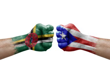Two hands punch to each others on white background. Country flags painted fists, conflict crisis concept between dominica and puerto rico