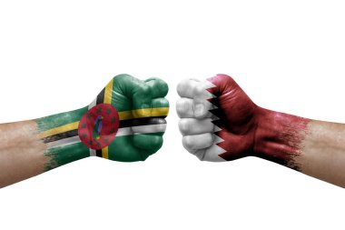 Two hands punch to each others on white background. Country flags painted fists, conflict crisis concept between dominica and qatar