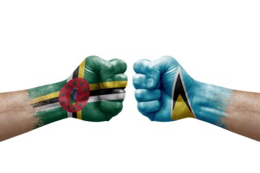 Two hands punch to each others on white background. Country flags painted fists, conflict crisis concept between dominica and saint lucia