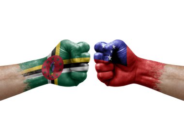 Two hands punch to each others on white background. Country flags painted fists, conflict crisis concept between dominica and samoa