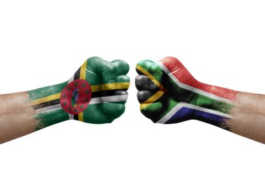 Two hands punch to each others on white background. Country flags painted fists, conflict crisis concept between dominica and south africa