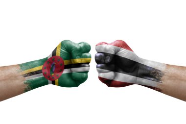 Two hands punch to each others on white background. Country flags painted fists, conflict crisis concept between dominica and thailand