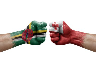 Two hands punch to each others on white background. Country flags painted fists, conflict crisis concept between dominica and tonga