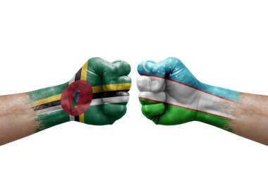 Two hands punch to each others on white background. Country flags painted fists, conflict crisis concept between dominica and uzbekistan