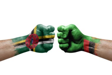 Two hands punch to each others on white background. Country flags painted fists, conflict crisis concept between dominica and zambia