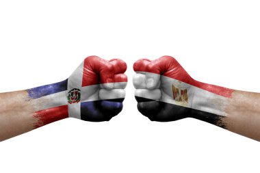 Two hands punch to each others on white background. Country flags painted fists, conflict crisis concept between dominican republic and egypt