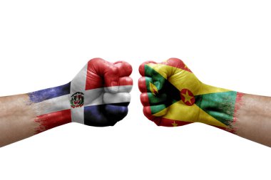 Two hands punch to each others on white background. Country flags painted fists, conflict crisis concept between dominican republic and grenada