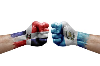 Two hands punch to each others on white background. Country flags painted fists, conflict crisis concept between dominican republic and guatemala