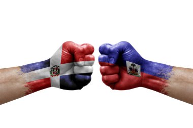 Two hands punch to each others on white background. Country flags painted fists, conflict crisis concept between dominican republic and haiti