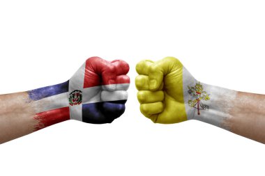 Two hands punch to each others on white background. Country flags painted fists, conflict crisis concept between dominican republic and holy see
