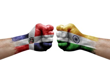 Two hands punch to each others on white background. Country flags painted fists, conflict crisis concept between dominican republic and india