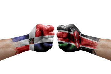Two hands punch to each others on white background. Country flags painted fists, conflict crisis concept between dominican republic and kenya