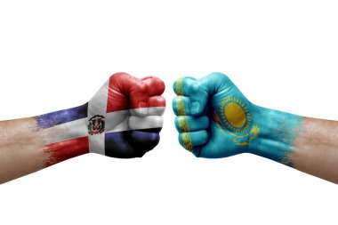 Two hands punch to each others on white background. Country flags painted fists, conflict crisis concept between dominican republic and kazakhstan