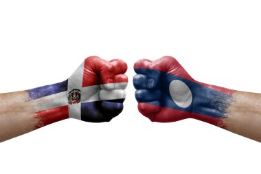 Two hands punch to each others on white background. Country flags painted fists, conflict crisis concept between dominican republic and laos