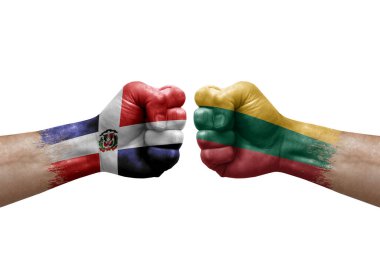 Two hands punch to each others on white background. Country flags painted fists, conflict crisis concept between dominican republic and lithuania
