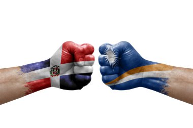 Two hands punch to each others on white background. Country flags painted fists, conflict crisis concept between dominican republic and marshall islands