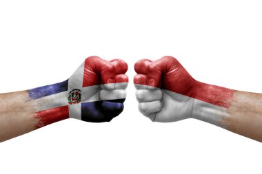 Two hands punch to each others on white background. Country flags painted fists, conflict crisis concept between dominican republic and monaco