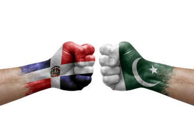Two hands punch to each others on white background. Country flags painted fists, conflict crisis concept between dominican republic and pakistan