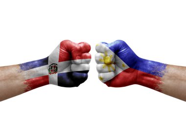 Two hands punch to each others on white background. Country flags painted fists, conflict crisis concept between dominican republic and philippines